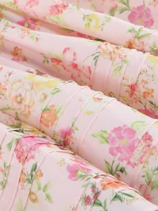 Macro detail of pink floral chiffon fabric with delicate pleating for a summer dress.