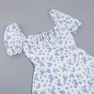 Close-up detail of a French floral dress with puff sleeves and a tie-up neckline