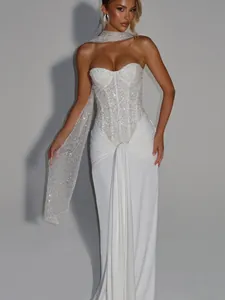 Detailed view of elegant white sequined strapless maxi dress with matching scarf for events