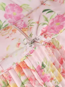 Close-up of metal hook and eye closure on a pink floral pleated summer dress detail