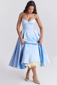 Elegant light blue corset midi dress with a full flared skirt and yellow tulle lining details.