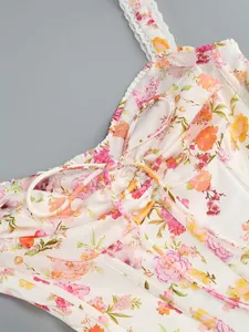 Macro detail view of floral print dress featuring lace straps and drawstring neckline