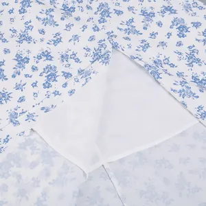 Close-up of French floral dress showing white lining and delicate blue flower pattern
