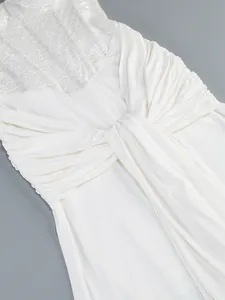 Close-up of white sequin bodice and ruched waist detail of elegant evening gown