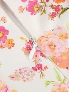Close-up of white invisible zipper on floral print dress fabric showing high quality stitching