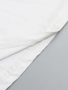 Close-up macro view of the high-quality white hem stitching on a slim fit evening dress