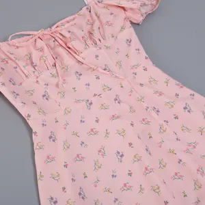 Close-up of pink French floral dress with puff sleeves and tie-up neckline detail