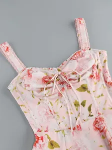 Close-up of floral print dress featuring lace straps and corset-style lace-up detail.