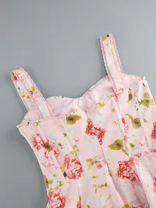 Detail view of a pink floral print dress featuring lace-trimmed straps and corset boning.