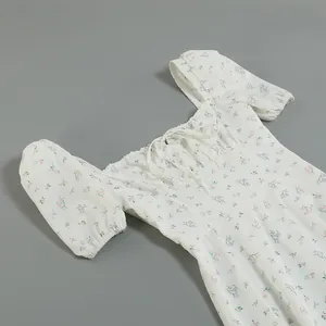 Detailed close-up of a French style floral dress with puff sleeves and square neck