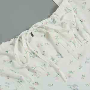 Close-up detail of French style floral dress showing drawstring neckline and delicate print