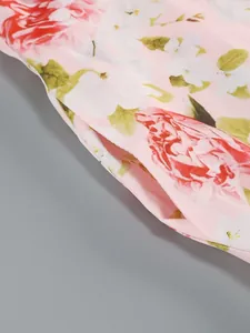 High-quality detailed close-up of a side pocket on a pink floral print midi dress