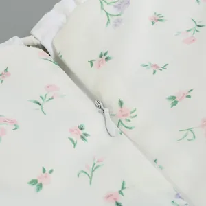 Detailed macro view of the high-quality invisible zipper and floral print on a white fabric