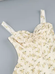 Close-up of floral print slip dress with lace straps and tie-front detail at bust
