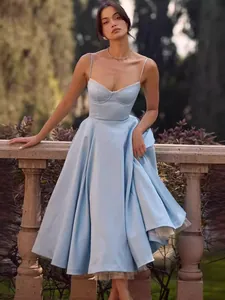 Elegant light blue spaghetti strap satin dress with a full skirt and bustier bodice