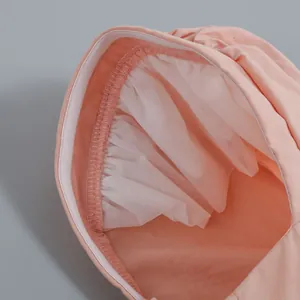 Close-up of peach dress detail showing inner mesh lining and elastic gathering
