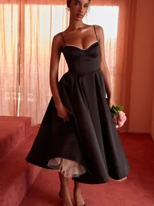Elegant black satin corset midi dress with a full skirt and a visible white tulle petticoat.