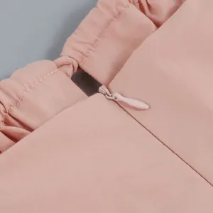 Close-up detail of a pink French style dress showing a hidden zipper and fabric texture