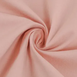 Macro close-up detail of soft pink cotton fabric showing woven texture and folds