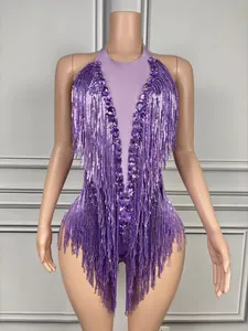 Detail of purple halter bodysuit featuring long sequined fringes and rhinestones