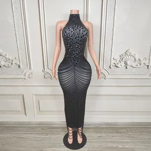 Detail of luxury black halter neck dress with sparkling rhinestones and beaded chains