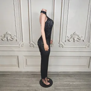 Side view of luxury black halter dress with intricate rhinestone chains on mannequin