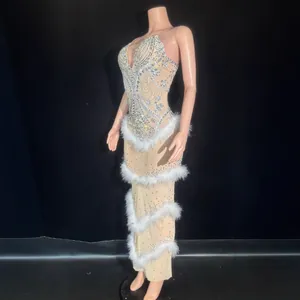 Stunning close-up of a luxury silver rhinestone evening gown with elegant white feather trim