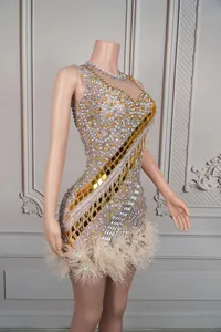Detailed view of luxury rhinestone and gold mirror fringe dress for stage performance