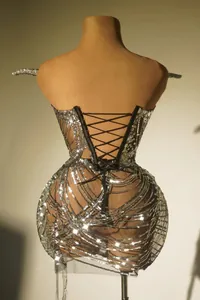 Detailed back view of a sexy silver sequined tube top dress with lace-up design