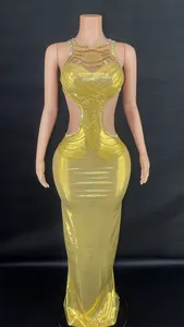 Close-up of elegant gold dress with side cut-outs and intricate rhinestone chain detailing.