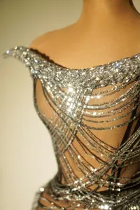 Close-up of sparkling silver sequins and rhinestones on a sexy party dress