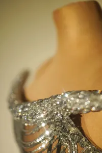 Close-up of shimmering silver sequins and rhinestones on a sexy evening party dress.
