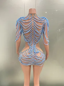 Detailed back view of a light blue skeletal rhinestone party dress with silver chains and gems