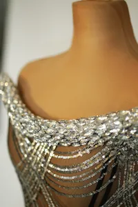 Detailed close-up view of silver rhinestones and sequins on a sexy evening party dress