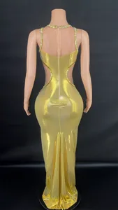 Detailed back view of gold metallic evening gown featuring side cut-outs and crystal trim