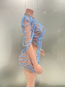 Close-up of a blue avant-garde performance dress with rhinestones and skeletal rope design