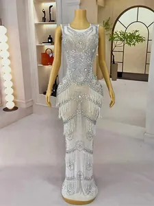 Full view detail of luxury white mermaid evening gown with silver rhinestones and fringe