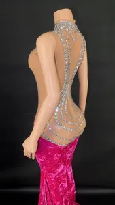 Detailed side view of high neck rhinestone velvet mermaid evening gown with mesh back