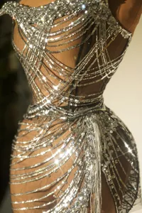 Close-up of shimmering silver sequins and rhinestones on a mesh evening gown
