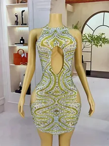 Close-up of mesh mini dress featuring intricate silver and green rhinestone patterns
