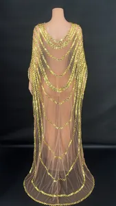 Back detail of elegant gold sequined mesh evening gown with cascading cape design.