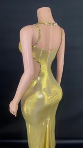 Elegant back view of gold cutout maxi dress with sparkling rhinestone trim detailing
