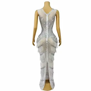 Detailed back view of a white mermaid evening gown with silver rhinestones and fringe