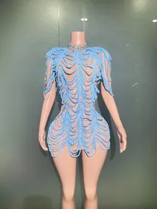 Detail view of an avant-garde light blue wave design evening dress with blue rhinestones