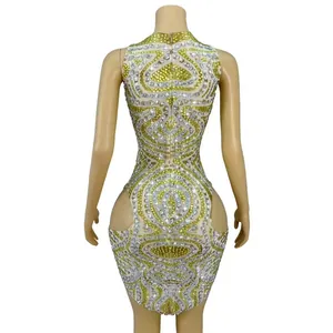 Back view of sexy mesh mini dress with yellow and silver rhinestone patterns and cutouts