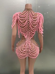 Back view of a unique pink plush rope dress with rhinestone accents for dance parties
