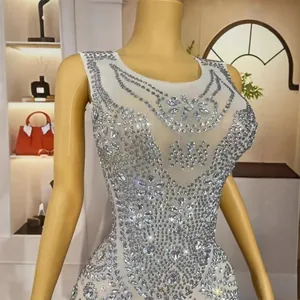 Elegant white mermaid evening dress featuring intricate rhinestone crystal embellishments
