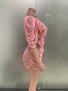 Detailed side view of pink textured rope party dress with rhinestone accents
