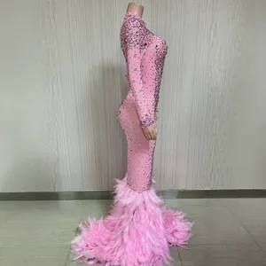 Elegante abito da sera rosa con strass e piume, modello a sirena e maniche lunghe.
