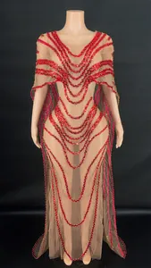 Detailed view of red sequin patterns on an elegant nude mesh cape design formal gown